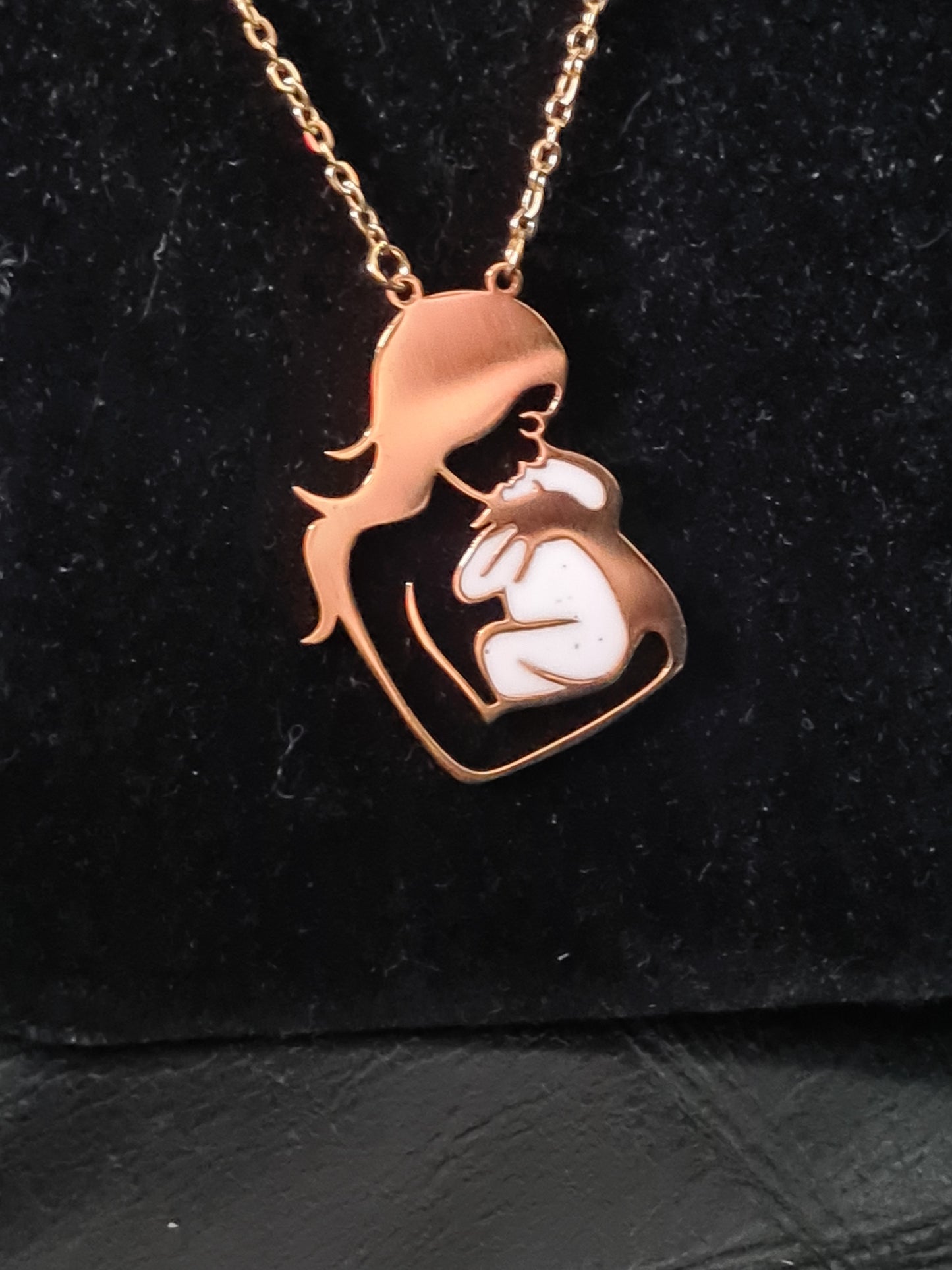 Mum holding newborn necklace