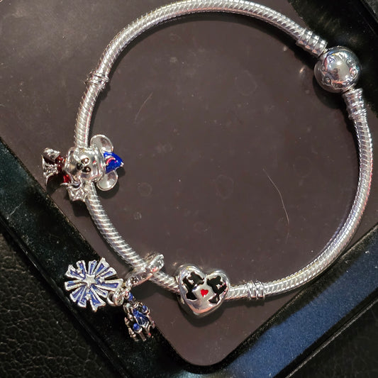 Disney charm bracelet and 3 charms