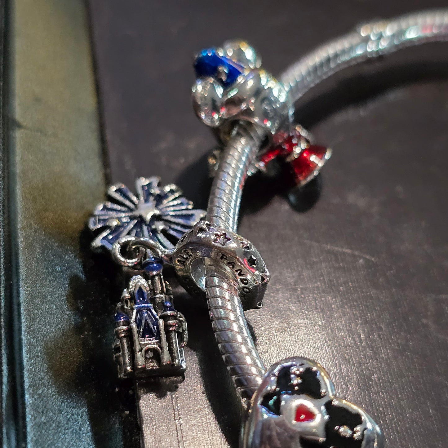 Disney charm bracelet and 3 charms