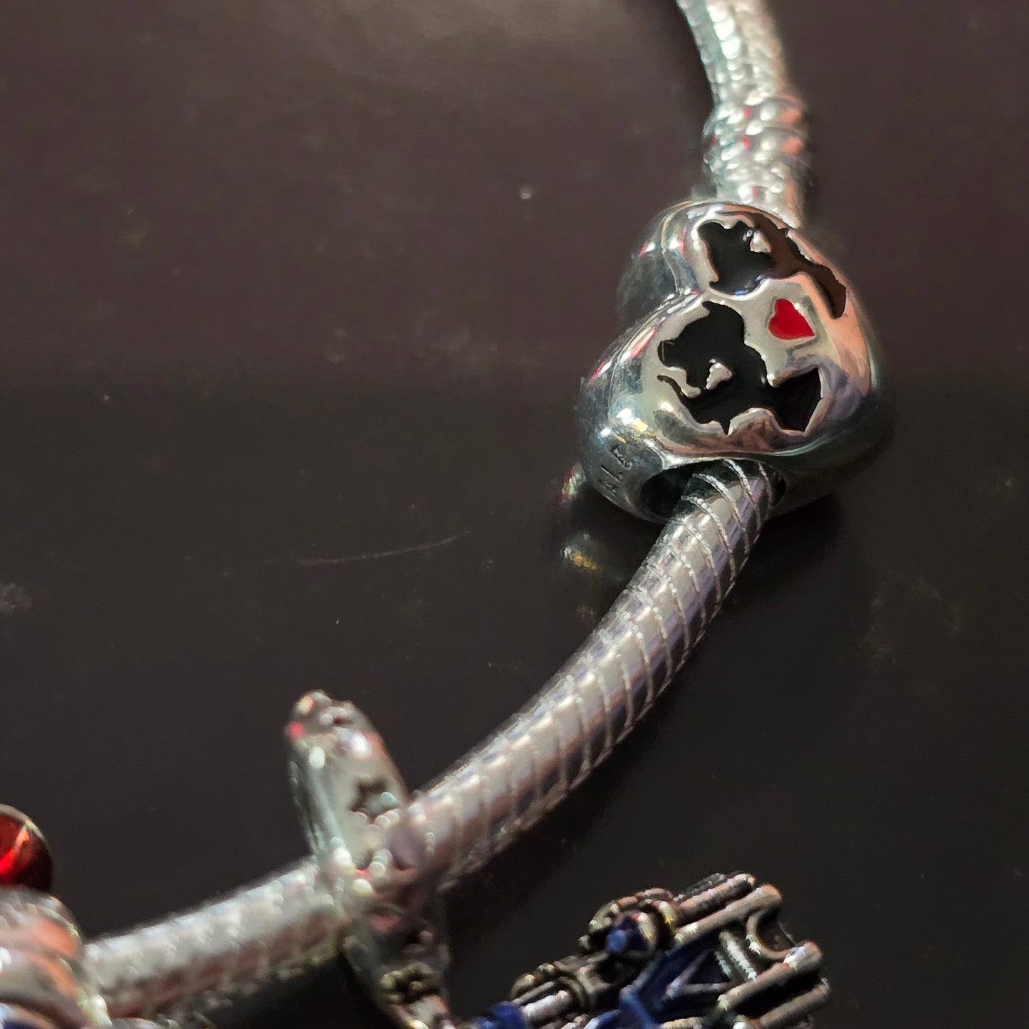 Disney charm bracelet and 3 charms