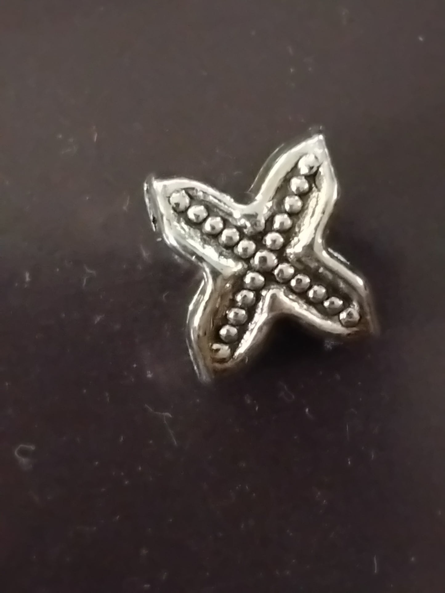 Spiked X charm